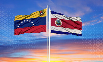 Venezuela and Costa Rica two flags on flagpoles and blue sky