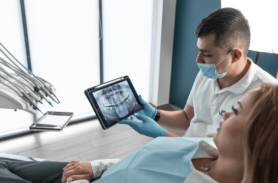 The dentist carefully examines the condition of the patient's oral cavity on CT and MRI images and develops an individual treatment plan. A modern medical center provides high quality treatment and