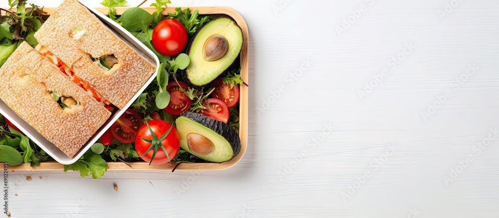 Poster healthy lunch box with sandwich and vegetables on office table top view flat lay. website header. cr