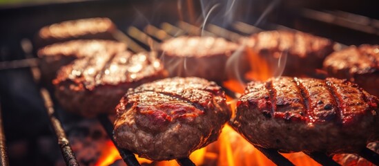 Juicy beef hamburger patties sizzling over hot flames on the barbecue. Website header. Creative...