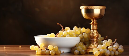 Holy communion a golden chalice with grapes and bread wafers. Website header. Creative Banner. Copyspace image - obrazy, fototapety, plakaty