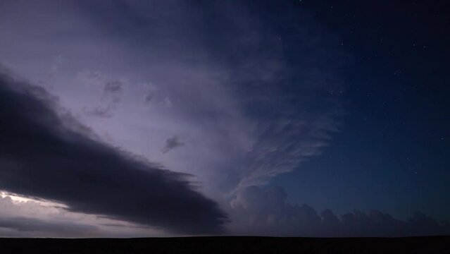 Epic thunderstorm moving clouds at night with lightning. Storm sky timelapse 