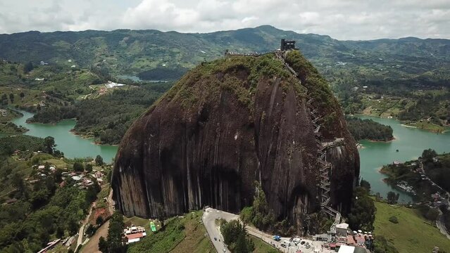Aerial drone footage of El Penon de Guatape near Medellin in Antioquia, Colombia. Large and unique alone rock with stairs to the top, touristic place. Big stone in Colombia. High quality 4k footage.