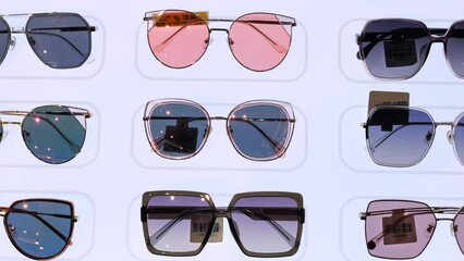 Style sunglasses displayed in store window shopping center. Fashionable glasses for every taste from latest collections from style brands. Visitors to store can try on glasses and buy style model.