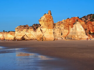 Fototapeta na wymiar Epic Algarve beach in Portimao with typical red cliffs