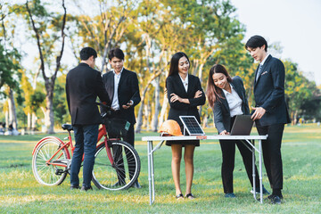 Group of asian business people with strong teamwork establish outdoor eco business office at natural park develop environmentally friendly and sustainable technology project for greener future. Gyre