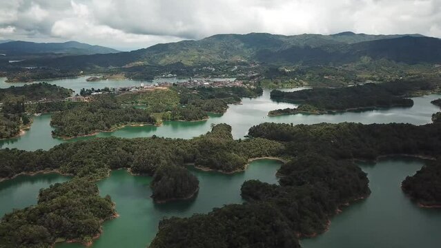 Aerial drone footage of flying helicopter near El Penon de Guatape, Medellin in Antioquia, Colombia. Touristic place. Big stone in Colombia. High quality 4k footage.
