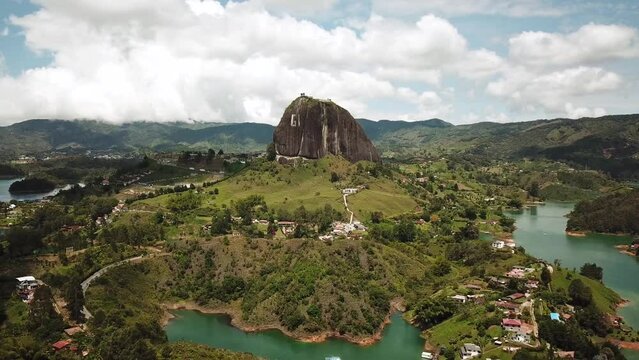 Aerial drone footage of El Penon de Guatape near Medellin in Antioquia, Colombia. Large and unique alone rock with stairs to the top, touristic place. Big stone in Colombia. High quality 4k footage.