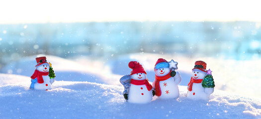 cute snowman friends on snowy landscape. Winter nature background. Christmas and new year holidays...