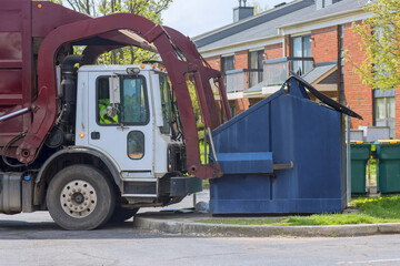 Municipal sanitation disposal service recycling garbage collector truck loading waste trash bin