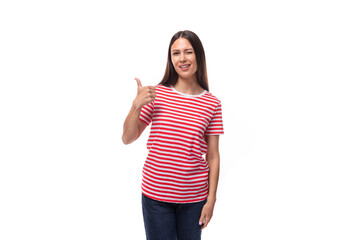a pretty young caucasian woman with dark straight hair in glasses and in a striped red t-shirt gestures with her hands on a white background