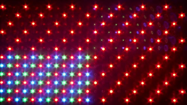 RGB LED Panel background with different effects. Multi-colored light of glowing light-emitting diodes. LED Panel with many luminous semiconductor diodes, close-up. LED dots red, green and blue colors