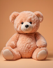 A fuzzy peach-colored teddy bear isolated on a peach color background. 