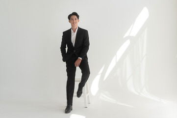 Fototapeta premium Portrait of young handsome groom in suit, preparing for wedding ceremony