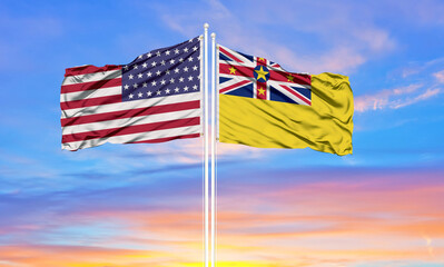 United States and Niue two flags on flagpoles and blue cloudy sky . Diplomacy concept, international relations