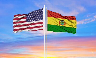 United States and Bolivia two flags on flagpoles and blue cloudy sky . Diplomacy concept, international relations