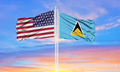 United States and Saint Lucia two flags on flagpoles and blue cloudy sky . Diplomacy concept, international relations