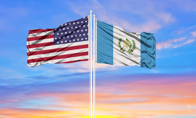 United States and Guatemala two flags on flagpoles and blue cloudy sky . Diplomacy concept, international relations