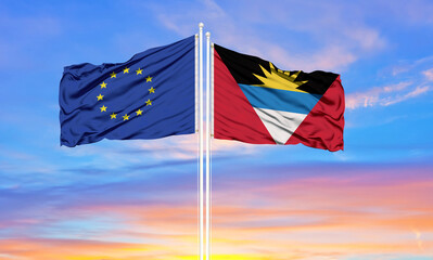European Union and Antigua and Barbuda two flags on flagpoles and blue cloudy sky . Diplomacy concept, international relations