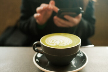 Matcha latte with art in coffee shop