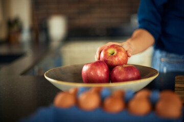 A close-up of a bowl full of apples, ready for making an apple pie.