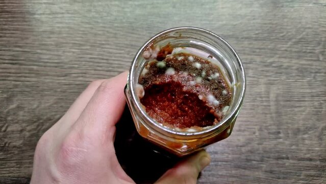 Spoiled jam covered with mold