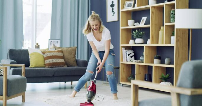 Woman, dancing and cleaning carpet with happy in living room, vacuum and housekeeping in home. Young person, cheerful and housework in lounge for carefree, relax wellness and weekend in apartment