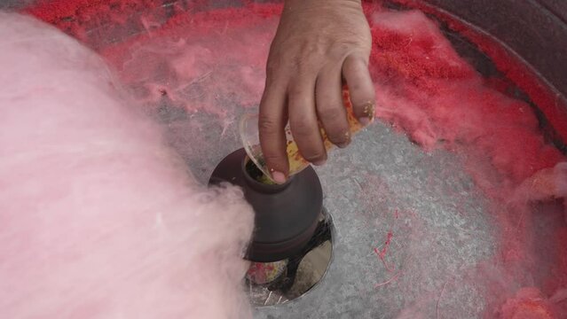 Pouring sugar into cotton candy machine slow motion