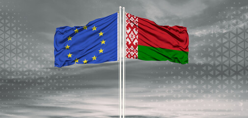 European Union and Belarus two flags on flagpoles and blue cloudy sky . Diplomacy concept, international relations
