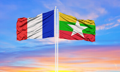france and Myanmar two flags on flagpoles and blue cloudy sky . Diplomacy concept, international relations