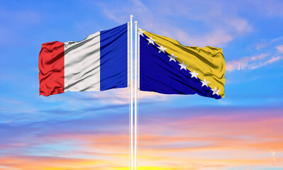 france and Bosnia and Herzegovina two flags on flagpoles and blue cloudy sky . Diplomacy concept, international relations