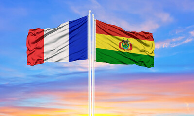 france and Bolivia two flags on flagpoles and blue cloudy sky . Diplomacy concept, international relations