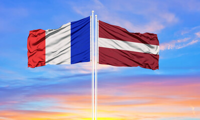 france and Latvia two flags on flagpoles and blue cloudy sky . Diplomacy concept, international relations