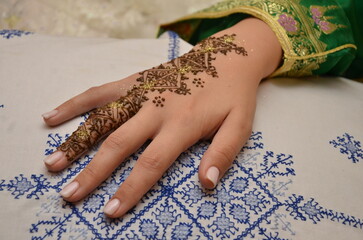 Woman with Moroccan henna painted hand.