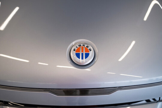 grey electric Fisker Ocean in showroom, Logo on cap, trends EV in Europe, technological advancements automotive industry, environmental cleanliness vehicle, Frankfurt - December 8, 2023