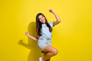 Naklejka premium Photo of positive cheerful girl celebrate winning in lottery raise fists up isolated over bright color background