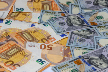 50 euro and 100 dollar bills scattered on the table as a background 2