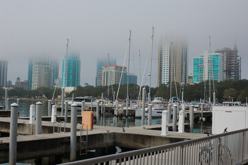 Vinoy Basin Saint Petersburg Florida with boats, docks and city skyline with low fog early morning. 