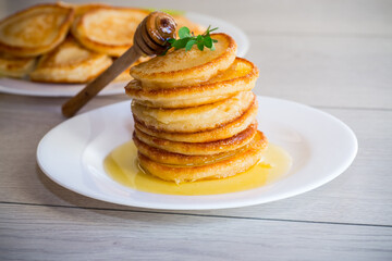 cooked sweet pancakes with honey in a plate