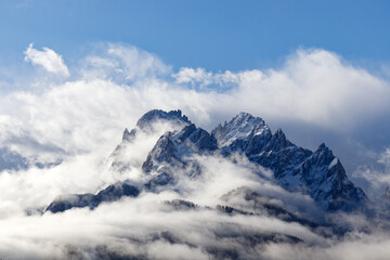 Snow covered peaks of the Sesto Dolomites with clouds in winter, mountains of the Alps, South...