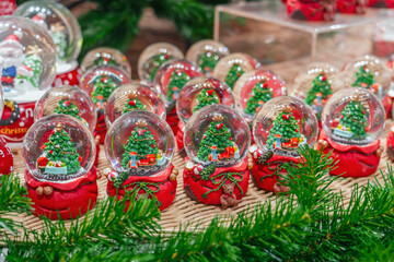 Lots of glass balls New Year tree and Christmas locomotive train with snow fair, market. © aapsky