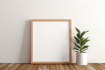 Fototapeta na wymiar Empty wooden picture frame mockup on table leaning on the white wall with a green plant.