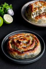 Traditional Turkish Rolled Borek Tepsi Böreği with feta cheese and spinach. Top view. Filo pastry.