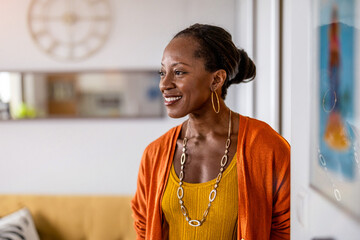 Portrait of a smiling mature woman standing in her apartment
