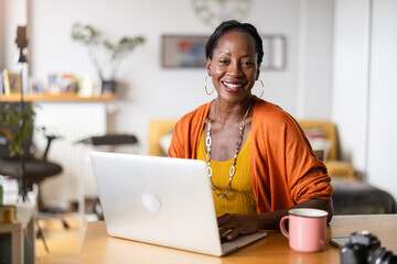 Mature woman working on laptop at home
