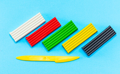 A group of different colored toothbrushes on a blue background. Group of Colorful Toothbrushes on Blue Background