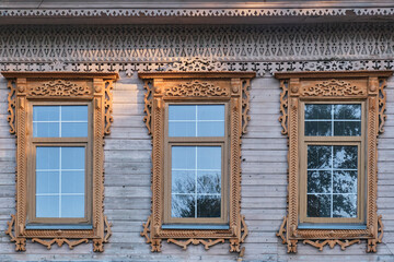 Typical windows with carved wood platbands on histotic house, Yelabuga, Russia