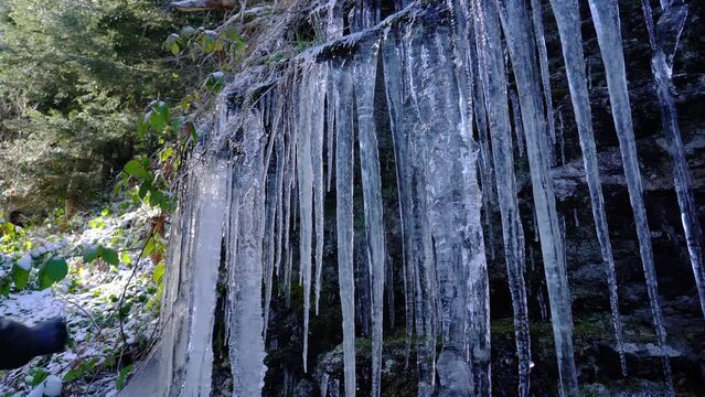 Winter Icicles on rocks in forest - (4K)