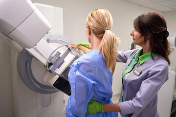 Caucasian woman being prepared for digital breast tomosynthesis
