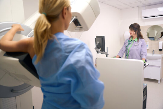 Female is getting 3D mammogram during diagnostic examination in clinic